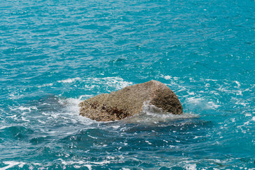 Obraz premium Stones sticking out of the purest blue ocean. Copy space.