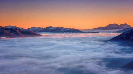 Amazing nature landscape, scenic panoramic top view of the Alps mountain range with clouds at sunset, outdoor travel background, Hohe Tauern national park, Carinthia, Austria