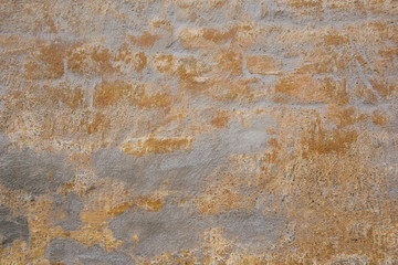 Obraz na płótnie Canvas gray vintage brick wall with gold scuffs