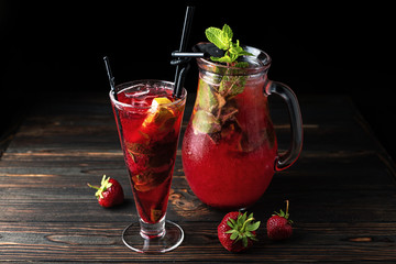 Lemonade a strawberry in a glass on a dark background