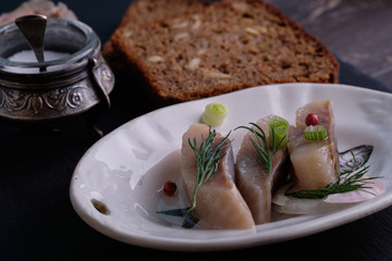 Scandinavian food herring with onion and brown bread