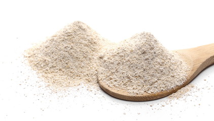 Barley flour pile with wooden spoon isolated on white background