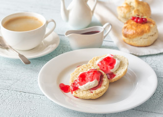Classic scones with cream and berry jam