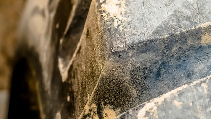 Panorama Close up of the dirty black rubber tire of a heavy duty construction vehicle