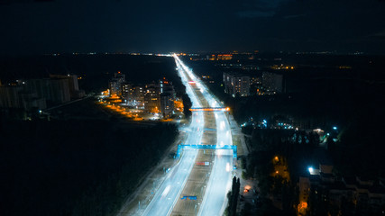 Hyperlapse timelapse of night city traffic fast cars driving around on the highway. Aerial view