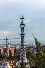 Overview of the Right Pavilion with a Pinnacle, crowned with a Gaudi-typical five-beam cross of the...