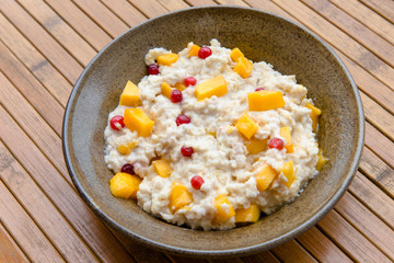 Oatmeal with mango and cranberries, healthy breakfast rich in vitamins and minerals