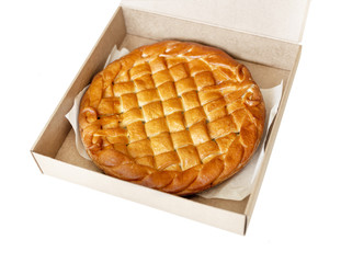 Traditional homemade rustic baked pie with seasonal fruit or meat filling in cardboard box isolated on white. Fast food to go. Bakery delivery menu. Flat lay. Copyspace