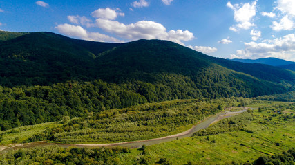 Fototapeta na wymiar aerial view of big green hills with lot of trees in mountains