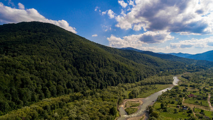 Fototapeta premium aerial view of green valley with river view in mountains 