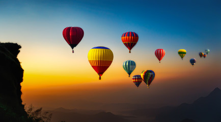 Hot air balloons flying over the sunrise mountain at phucheefa mountain. Chiang Rai Province, Thailand