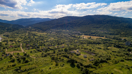 aerial shoot of green landscape in the mountains