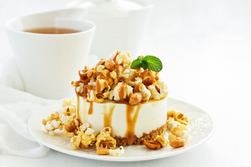 A delicious New York chocolate cheesecake with popcorn and caramel. close-up.