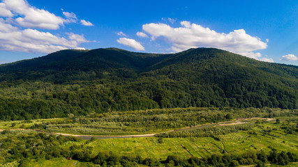 Fototapeta na wymiar aerial shoot of green landscape in the mountains