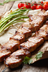 pork skewers on a wooden table, selective focus