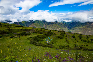 Fototapeta na wymiar Mountain landscape beautiful green mountains with Alpine lush meadows cloudy sky background.