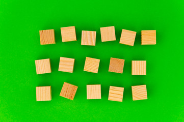 empty space for your text on wooden cubes on green background. any three words for an advertising...