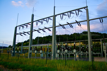 Obraz premium Power transformer in high voltage switchyard in modern electrical substation in Hesse, Germany