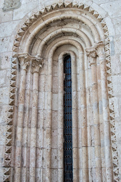 fragment of narrow Romanesque window on a church facade
