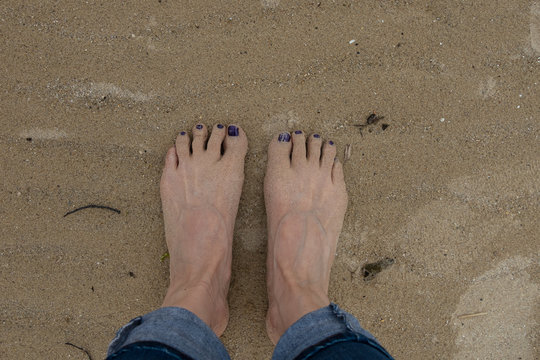 feet of a woman in the sand