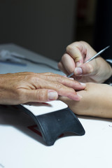 woman getting a manicure at beauty salon