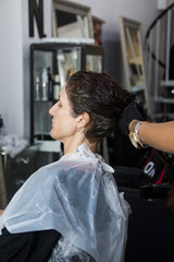 Woman dyeing her hair at a beauty salon