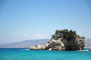 Naklejka premium A dragon-like cliff on a beach with bright blue water in Albania