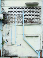 aged street wall with pipe, old home