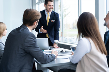 Businesspeople discussing together in conference room during meeting at office.