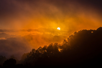 Obraz premium Dramatic sky of sunrise covered by cloud and fog