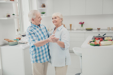 Fototapeta premium Portrait of nice pretty married person people hold hand look enjoy culinary cuisine stand kitchen indoors