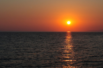 sunset over the sea, clear (reddish) sky