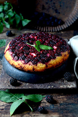 Upside down blackberry cake on a dark wooden table