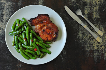 Keto lunch or dinner. Green peas with meat steak on a plate. Keto diet. Paleo Diet. Pegan diet.