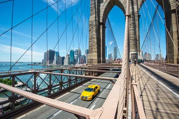 Zelfklevend Fotobehang New York Manhattan skyline from the Brooklyn Bridge with yellow taxi © Lukas Uher