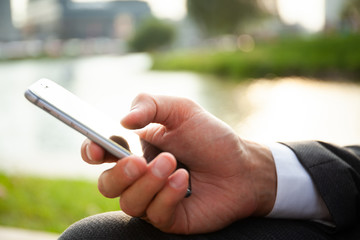 Close up of a man using mobile smart phone.