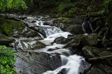Naklejka na ściany i meble Hulski stream flows through the small Szepit Waterfall in the Bieszczady Mountains.
