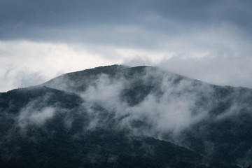 Clouds rise up from the mountaintops in the Bieszczady Mountains.