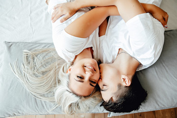 Fototapeta na wymiar young lovely couple lying in a bed, happy smile
