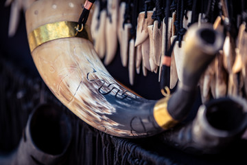 Ornamental carved horn hanging in front of bones