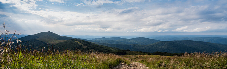 A panorama of the Bieszczady Mountains, with Szare Berdo pass and the Smerek peak visible at the left, seen from Połonina Wetlińska, from the Osadzki Wierch approach.