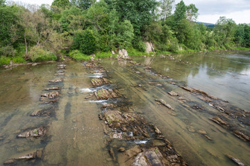 San river flows over parallel rock formations in the Bieszczady Mountains.