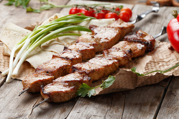 pork skewers on a wooden table, selective focus
