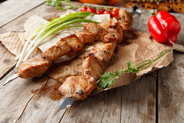 pork skewers on a wooden table, selective focus