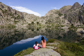 Fototapeta premium Mother and daughter enjoying at the lake