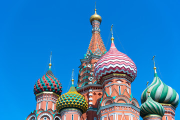 Fototapeta na wymiar Multicolor towers of St. Basil's Cathedral against a blue sky, Red Square, Moscow, Russia.