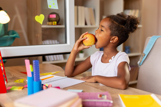Schoolgirl eating an apple