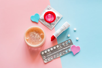 contraceptives and cosmetics on a colored background