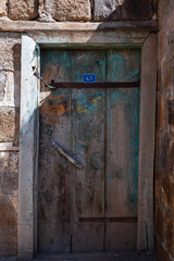 Part of the destroyed house. Old painted wooden door.