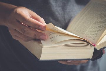 Naklejka premium Close up hand open the Bible,Sunday readings, Bible